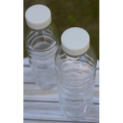 two_pure_bottle_white_flower_of_life_on_table_outside_bioplastic_lid_500ml_natures_design_serenity_plus